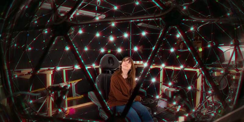a student sitting in the lightstage in the computer science building